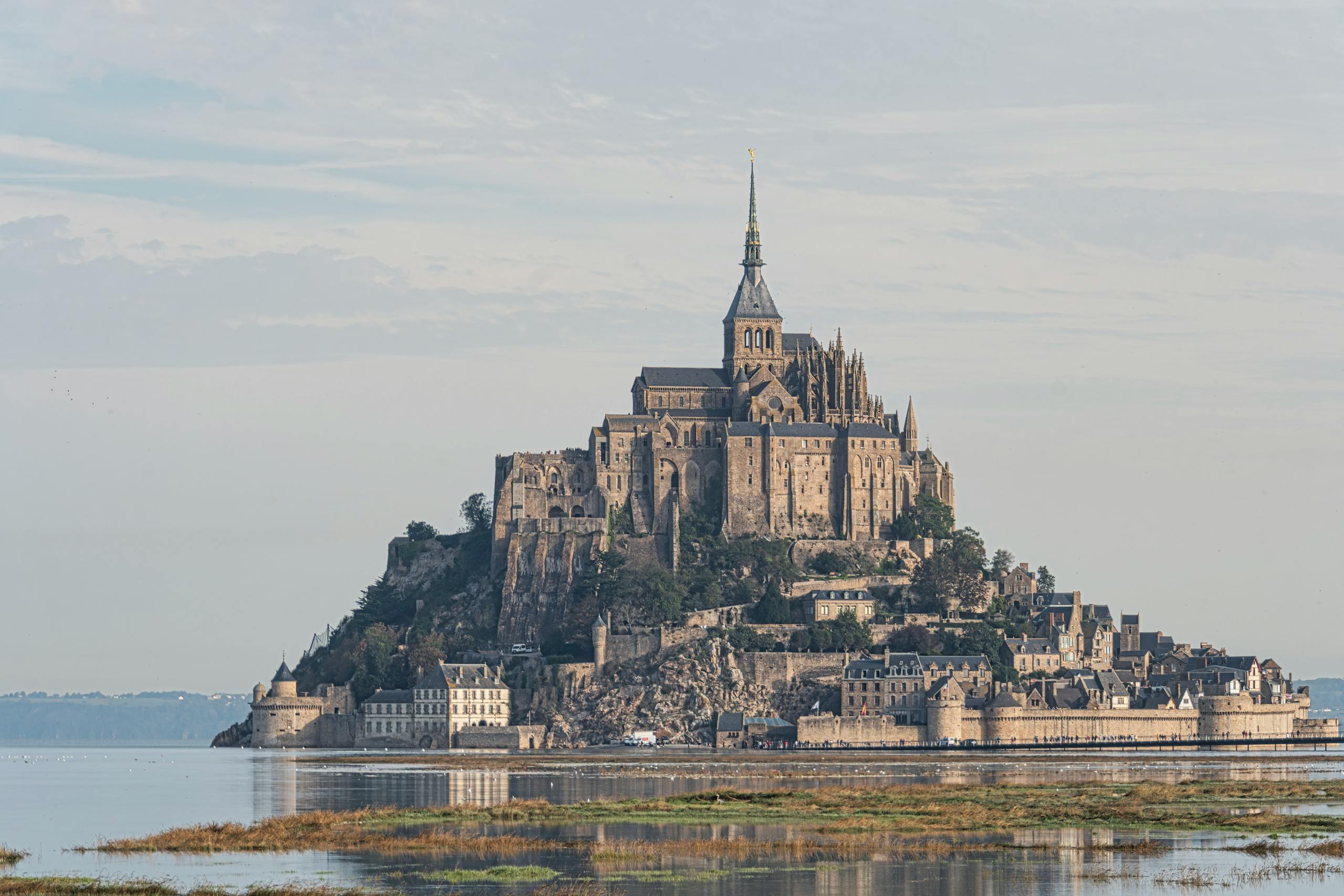 Captivating image of Mont Saint-Michel, a historic island commune and abbey in France, during the evening.